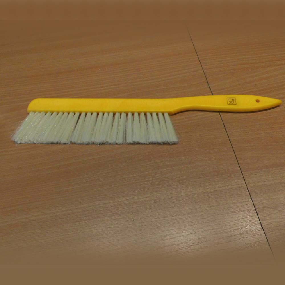 Brush with nylon bristles to gently sweep bees from the frame